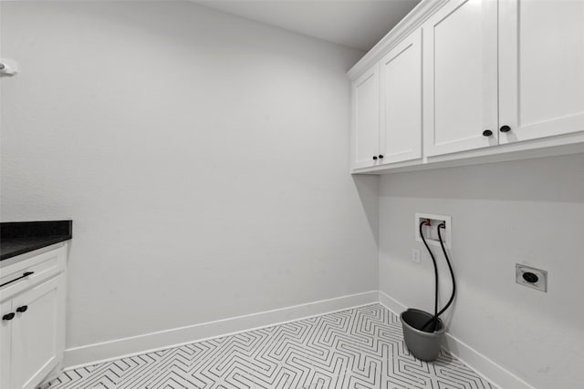 laundry room with cabinet space, washer hookup, baseboards, and electric dryer hookup