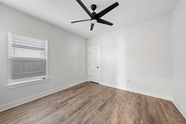 unfurnished room with wood finished floors, baseboards, and ceiling fan
