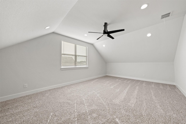 additional living space featuring lofted ceiling, visible vents, and recessed lighting