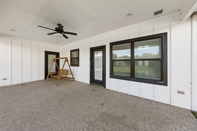 interior space with a ceiling fan and visible vents