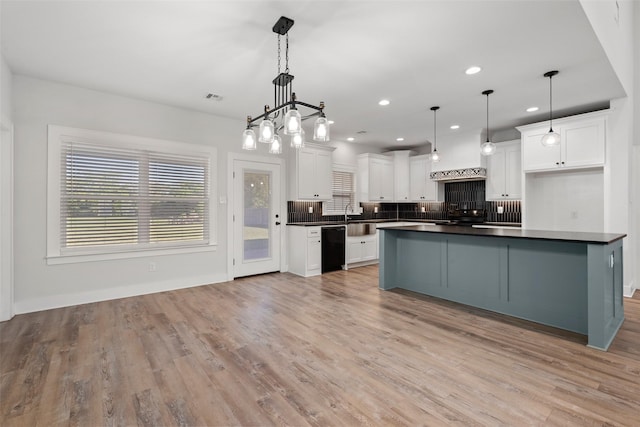 kitchen with dark countertops, backsplash, white cabinetry, black dishwasher, and visible vents