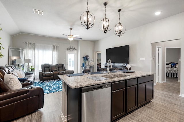 kitchen featuring open floor plan, stainless steel dishwasher, visible vents, and a sink