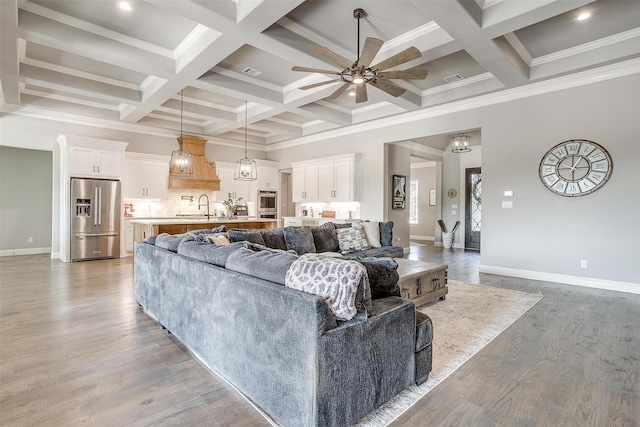 2161 Eagles Ridge Dr, Weatherford, TX 76087 - living room with beam ceiling, ornamental molding, a ceiling fan, coffered ceiling, and baseboards
