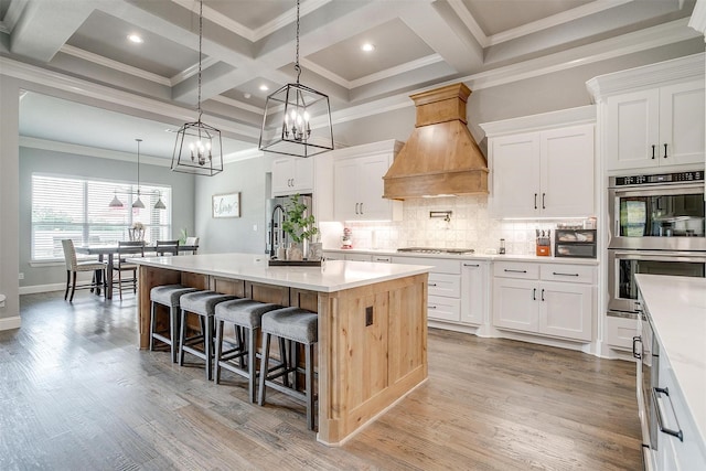 2161 Eagles Ridge Dr, Weatherford, TX 76087 - kitchen featuring premium range hood, an inviting chandelier, stainless steel appliances, and coffered ceiling