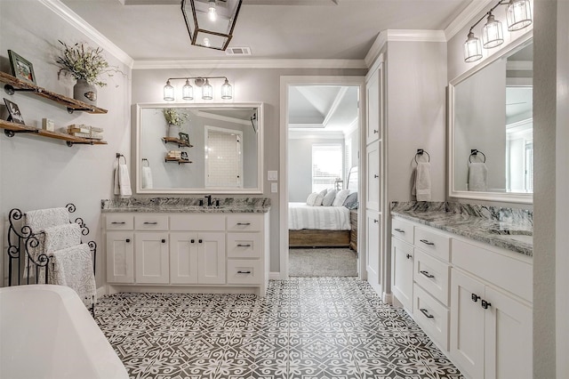 2161 Eagles Ridge Dr, Weatherford, TX 76087 - full bath featuring two vanities, baseboards, a freestanding tub, and ornamental molding