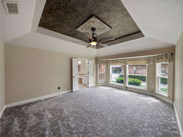 2516 Pepper Tree Cir, Mckinney, TX 75072 - carpeted empty room featuring a ceiling fan, a tray ceiling, visible vents, and baseboards