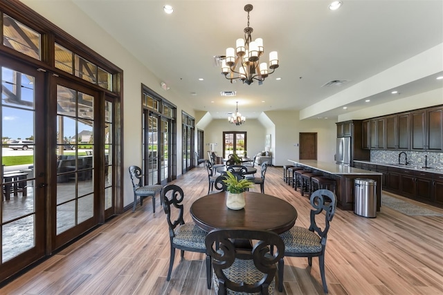 dining space with a notable chandelier, french doors, and recessed lighting