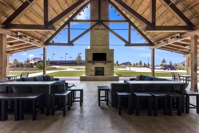 view of patio / terrace featuring an outdoor living space with a fireplace and a gazebo