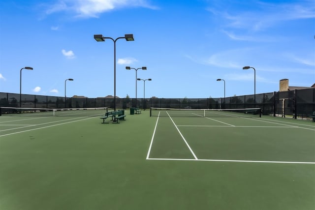 view of tennis court with fence