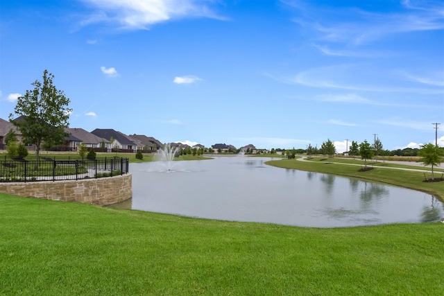 property view of water featuring fence and a residential view