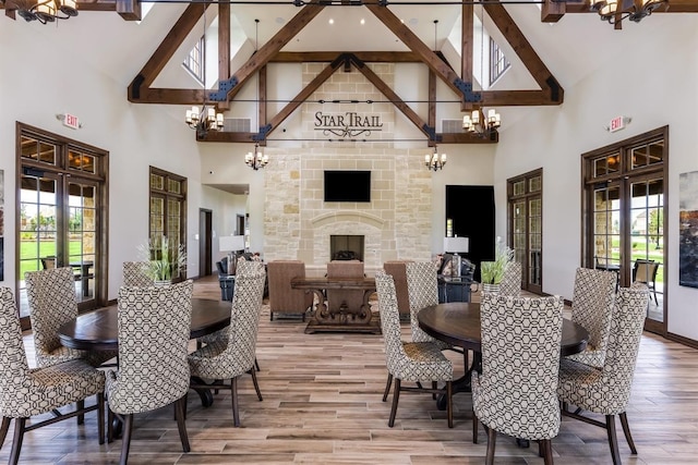 dining area featuring french doors, an inviting chandelier, and high vaulted ceiling