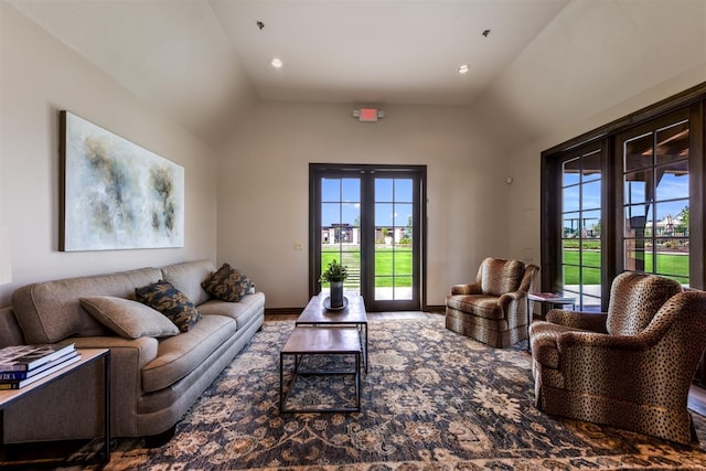 living room with lofted ceiling and a wealth of natural light