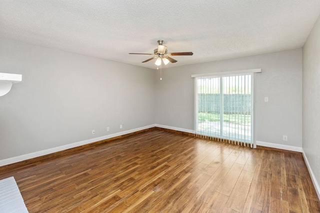 empty room featuring baseboards, a ceiling fan, wood finished floors, and a textured ceiling