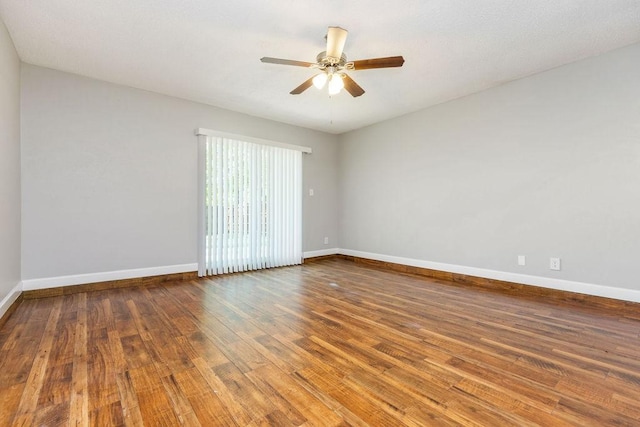 empty room with a ceiling fan and baseboards