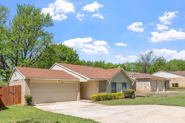 ranch-style house featuring fence, concrete driveway, brick siding, and a garage