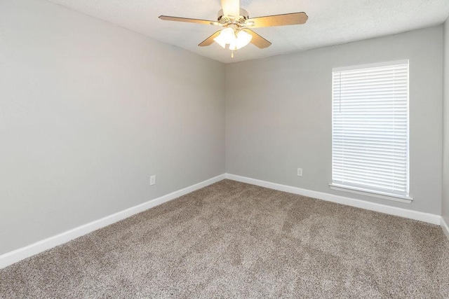 unfurnished room with ceiling fan, carpet floors, a healthy amount of sunlight, and baseboards