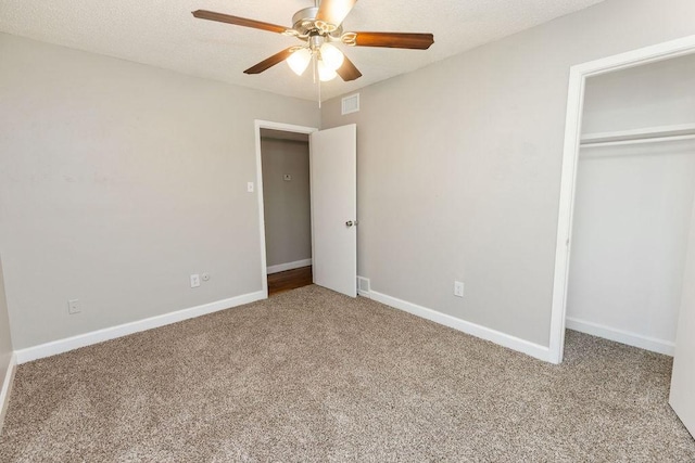 unfurnished bedroom featuring a closet, carpet, visible vents, and baseboards