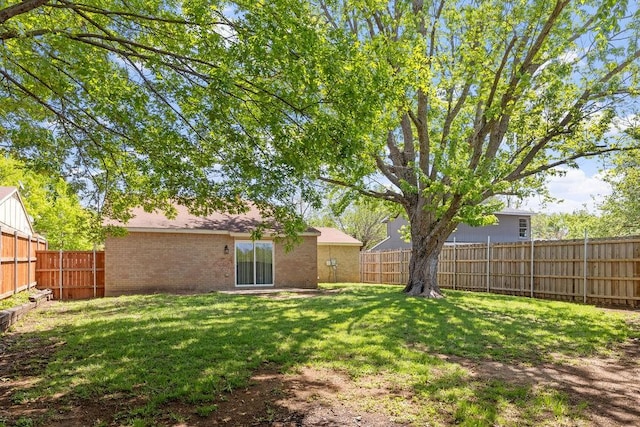 view of yard with a fenced backyard