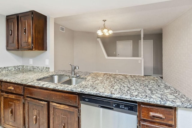 kitchen with visible vents, stainless steel dishwasher, light stone counters, and a sink