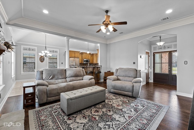 140 Fitzwilliam St, Haughton, LA 71037 - living room with dark wood-style floors, visible vents, arched walkways, and ceiling fan with notable chandelier
