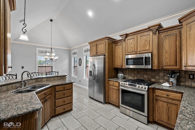 140 Fitzwilliam St, Haughton, LA 71037 - kitchen featuring a sink, brown cabinets, decorative backsplash, vaulted ceiling, and appliances with stainless steel finishes