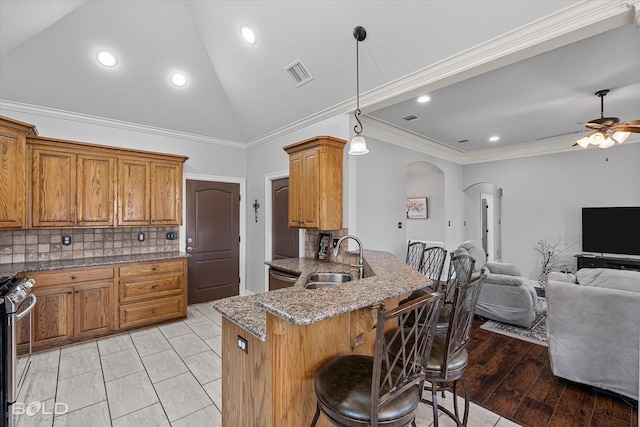 140 Fitzwilliam St, Haughton, LA 71037 - kitchen featuring arched walkways, a breakfast bar, stainless steel appliances, visible vents, and open floor plan