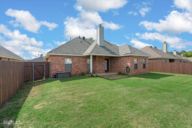 140 Fitzwilliam St, Haughton, LA 71037 - rear view of property with a patio, brick siding, a fenced backyard, and a yard