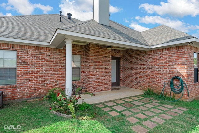 140 Fitzwilliam St, Haughton, LA 71037 - entrance to property with a patio, roof with shingles, and brick siding