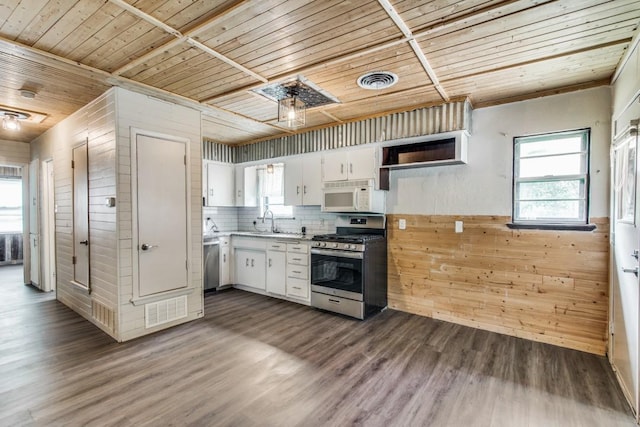 818 N Hughes St, Howe, TX 75459 - kitchen featuring white cabinets, visible vents, wood walls, wood ceiling, and appliances with stainless steel finishes