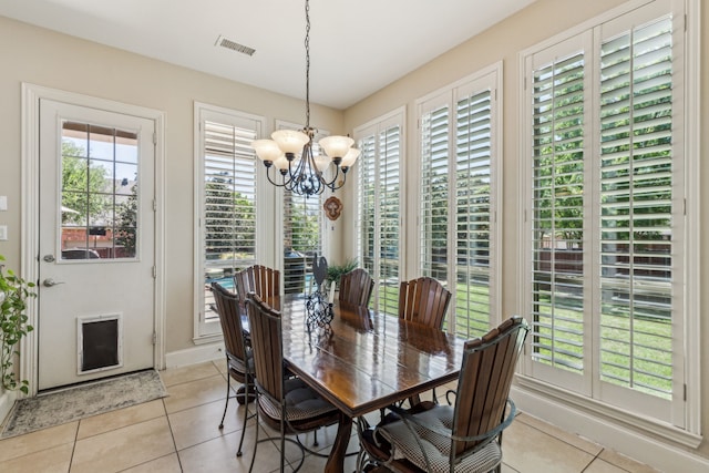 dining area with baseboards, light tile patterned flooring, a chandelier, and visible vents
