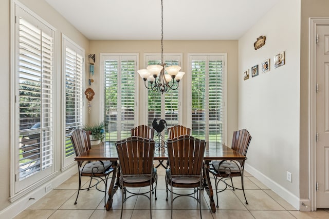 dining area featuring a wealth of natural light, a notable chandelier, and light tile patterned floors