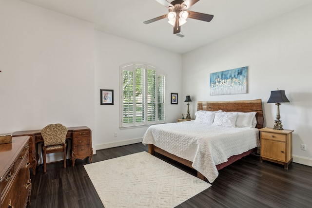 bedroom with dark wood finished floors, baseboards, visible vents, and ceiling fan