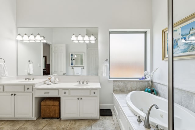 bathroom with tile patterned floors, a whirlpool tub, a sink, and double vanity