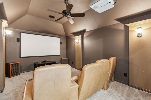cinema room featuring vaulted ceiling, a ceiling fan, carpet flooring, visible vents, and ornate columns