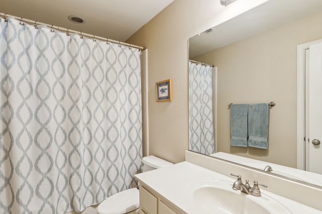 full bath featuring visible vents, toilet, and vanity