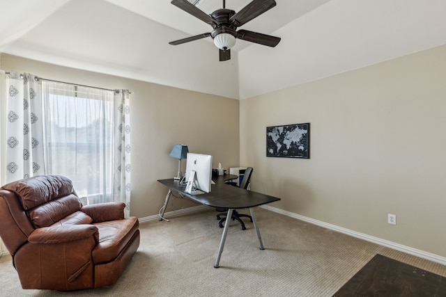 carpeted home office featuring baseboards and ceiling fan