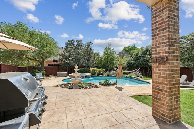view of pool featuring a fenced backyard, a patio area, a pool with connected hot tub, and area for grilling