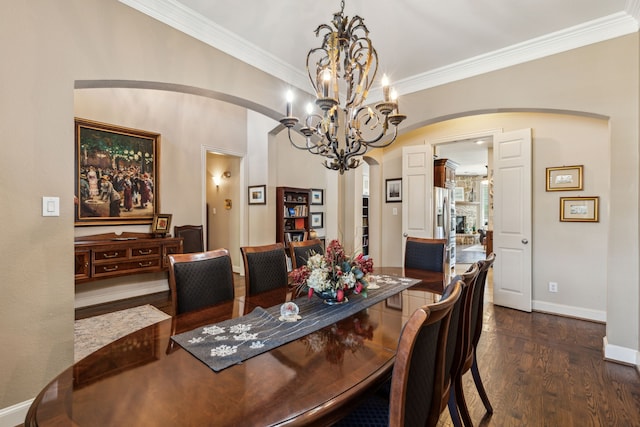 dining room with baseboards, arched walkways, dark wood finished floors, and crown molding