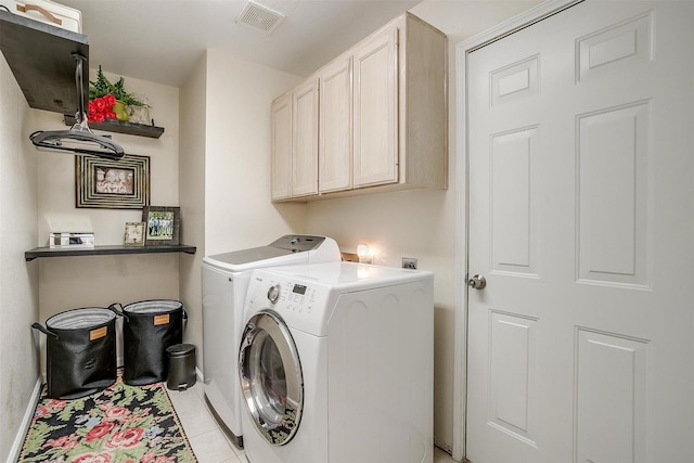 laundry room with washing machine and clothes dryer, light tile patterned floors, cabinet space, baseboards, and visible vents