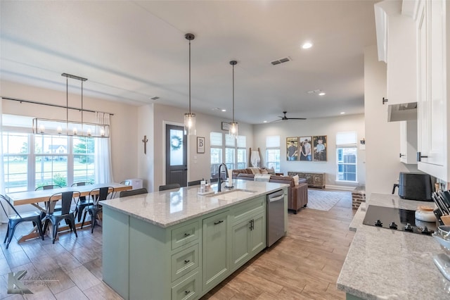 kitchen with a sink, dishwasher, green cabinets, white cabinets, and visible vents
