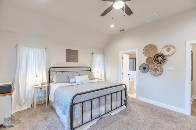 carpeted bedroom with lofted ceiling, baseboards, ensuite bathroom, and visible vents