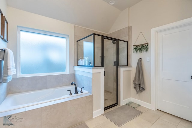 bathroom featuring tile patterned floors, a garden tub, vaulted ceiling, and a shower stall