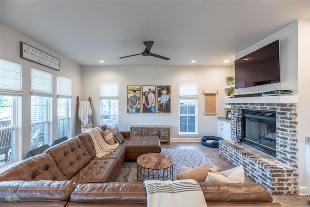 living area with recessed lighting, a ceiling fan, wood finished floors, and a fireplace