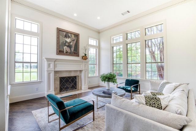 living room featuring ornamental molding, visible vents, and a healthy amount of sunlight