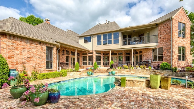 view of pool featuring a patio and a pool with connected hot tub