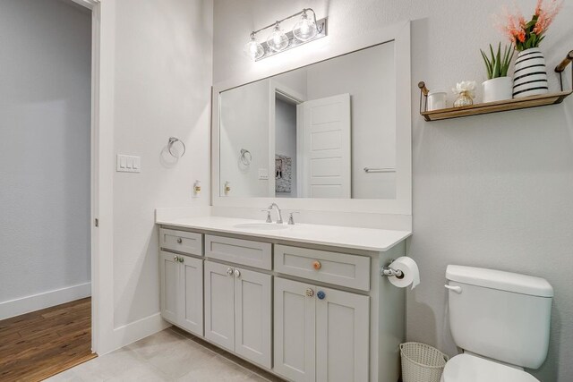 1833 Crested Ridge Rd, Fort Worth, TX 76008 - bathroom featuring toilet, baseboards, and vanity