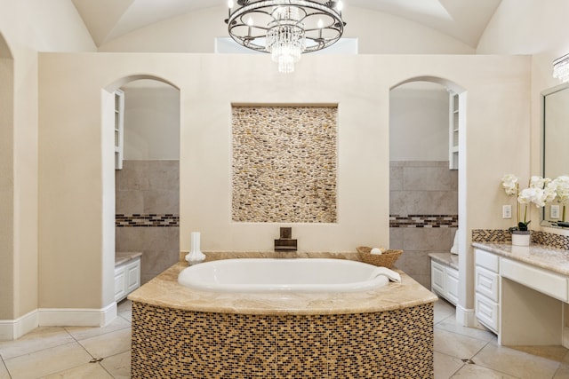 4161 San Juan Ave, Prosper, TX 75078 - bathroom featuring lofted ceiling, a garden tub, tile patterned flooring, and a chandelier