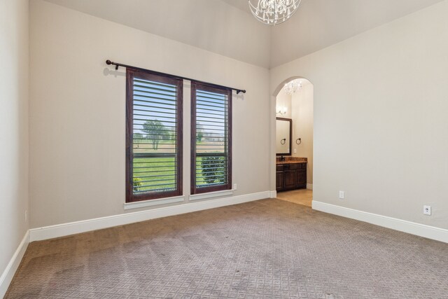4161 San Juan Ave, Prosper, TX 75078 - carpeted empty room with arched walkways, baseboards, and an inviting chandelier