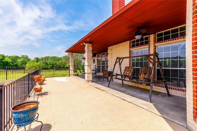 view of patio / terrace featuring fence and ceiling fan