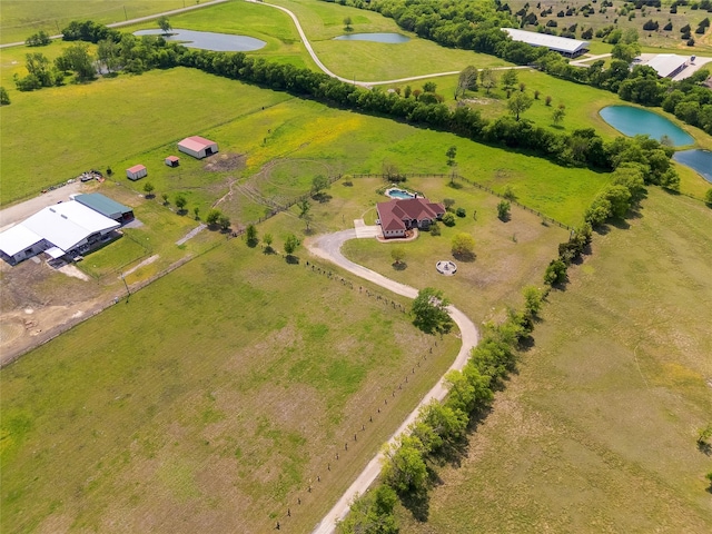 birds eye view of property with a rural view and a water view